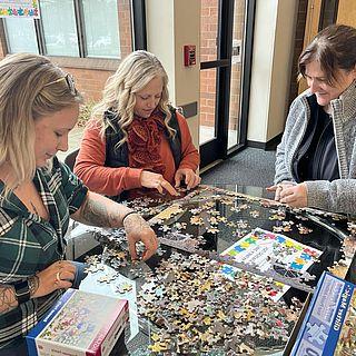 3 students work on a puzzle